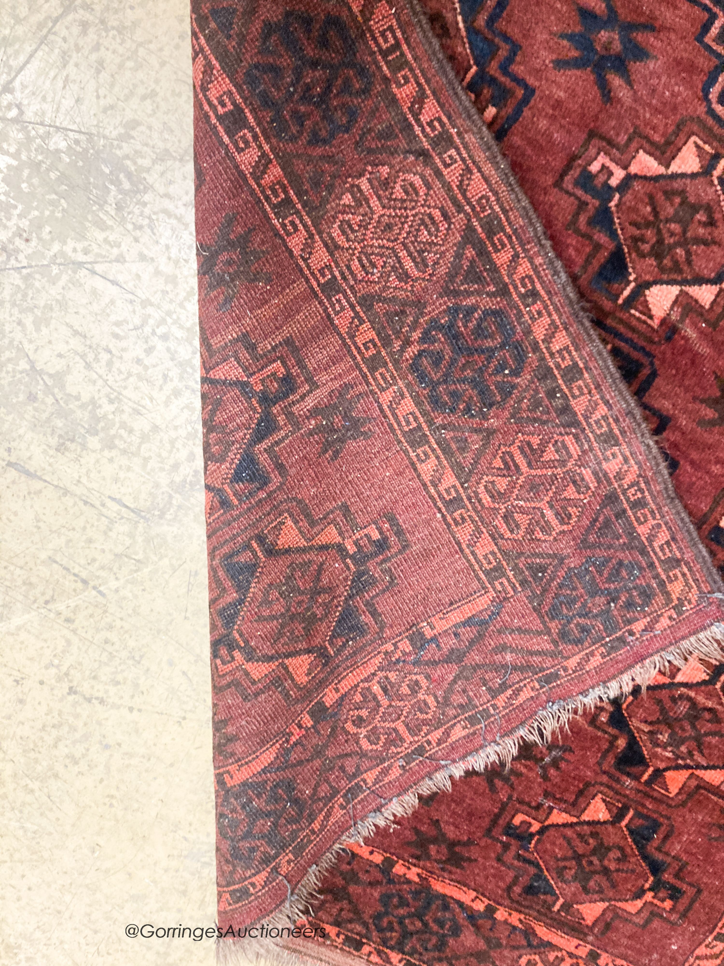 A Bokhara burgundy ground rug, 190 x 105cm